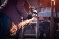 Worker cuts metal grinder. Sparks fly Royalty Free Stock Photo