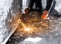 Worker cuts a metal pipe with sparks Royalty Free Stock Photo