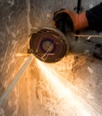 Worker cuts a metal pipe with sparks Royalty Free Stock Photo