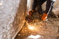 Worker cuts a metal pipe with sparks Royalty Free Stock Photo