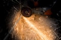 Worker cuts a metal pipe with sparks Royalty Free Stock Photo