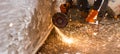 Worker cuts a metal pipe with sparks Royalty Free Stock Photo