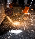 Worker cuts a metal pipe with sparks Royalty Free Stock Photo