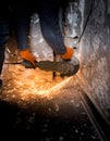 Worker cuts a metal pipe with sparks Royalty Free Stock Photo