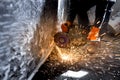 Worker cuts a metal pipe with sparks Royalty Free Stock Photo