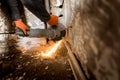 Worker cuts a metal pipe with sparks Royalty Free Stock Photo