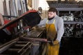 Worker cuts metal profile pipe on a band saw Royalty Free Stock Photo