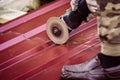 The worker cuts a metal sheet with angle grinder Royalty Free Stock Photo