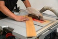 Worker cuts the parquet manually on a circular saw