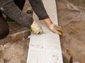 Worker cuts plastic at a construction site