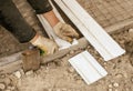 Worker cuts plastic at a construction site