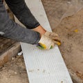 Worker cuts plastic at a construction site