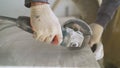 The master cuts the tiles on an angle grinder with a special diamond disc. Cutting large ceramic tiles. The worker cuts Royalty Free Stock Photo