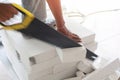 Worker cutting bricks with crosscut saw. Royalty Free Stock Photo