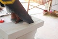 Worker cutting bricks with crosscut saw. Royalty Free Stock Photo