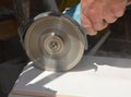 Worker cutting ceramic tile with disc grinder machine Royalty Free Stock Photo