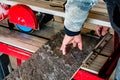 A worker is cutting a ceramic tile on a wet cutter saw machine. Royalty Free Stock Photo