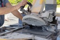 Worker with cutting ceramic tile on wet saw machine. Royalty Free Stock Photo
