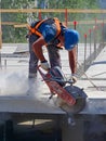 Worker cutting concrete