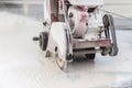 Worker cutting concrete road with diamond saw blade machine Royalty Free Stock Photo