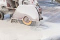 Worker cutting concrete road with diamond saw blade machine Royalty Free Stock Photo