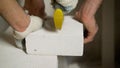 Worker cutting construction blocks made from aerated concrete using handsaw. A worker cuts an aerated concrete block. Royalty Free Stock Photo