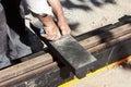 Worker cutting damping material for tram tracks Royalty Free Stock Photo