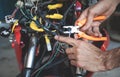 Worker cutting electrical wires with pliers Royalty Free Stock Photo