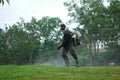 Worker cutting grass