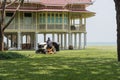 Worker cutting grass lawn mower in green field in garden .Beautiful house background Royalty Free Stock Photo