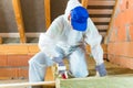 Worker cutting insulating material Royalty Free Stock Photo