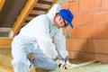 Worker cutting insulating material Royalty Free Stock Photo