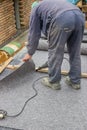 Worker cutting insulation material for basement wall 2