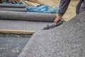 Worker cutting insulation material for basement wall 3