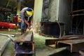 Worker cutting iron at construction project.