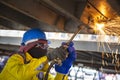 Worker is cutting manually old metal construction