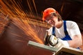 Worker cutting metal