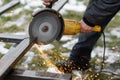 Worker cutting metal with angle grinder machine for welding iron. Close up of circular grinder disc and electric sparks. Workers Royalty Free Stock Photo