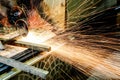 Worker cutting metal with grinder. Sparks while grinding iron