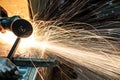 Worker cutting metal with grinder. Sparks while grinding iron