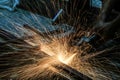 Worker cutting metal with grinder. Sparks while grinding iron