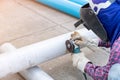 Worker cutting metal with grinder, wear gloves and face shield Royalty Free Stock Photo