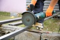 Worker cutting metal pole in construction zone Royalty Free Stock Photo