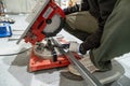 Worker cutting metal profile with chop saw Royalty Free Stock Photo