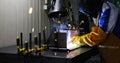 Worker cutting metalsheet by acetylene torch with bright sparks