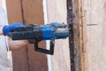 Worker cutting old beam using a chainsaw close up. Royalty Free Stock Photo