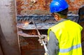 Worker is cutting old metal industrial equipment with acetylene torch