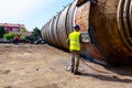 Worker is cutting old metal industrial equipment with acetylene torch