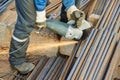 Worker cutting rebar by grinding machine