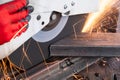 Worker Cutting of a Rectangular Steel Tube With a Circular Saw, creating sparks